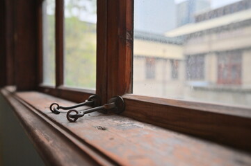 Obraz premium TW - 01.24.24: The wooden framed windows inside Songshan Cultural and Creative Park (formerly Songshan Tobacco Factory), built in 1937, bear witness to Taiwan's industrial and architectural history.