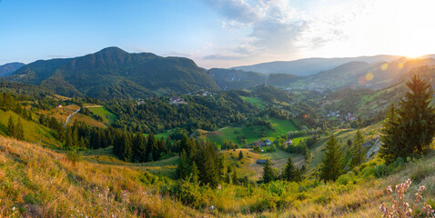Fototapeta na wymiar Sunset view of a village in a valley in Transylvania, Romania