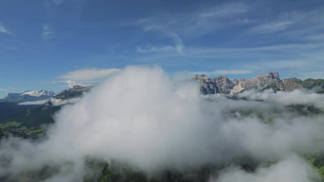 Aerial footage of a drone flying through clouds slowly turning right unveiling the peak Sass de Putia. Embark on an enchanting aerial journey through the Dolomites. LuPa Creative