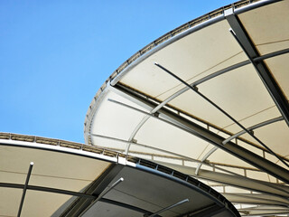 Exterior view of rounded roof with blue sky.