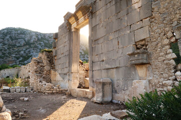 Golden hour at the giant sella, cella door, entrance to Ionic Temple at the ancient site of Olympos, Olympus, built in the name of the Roman Emperor Marcus Aurelius, close to Antalya, Turkey