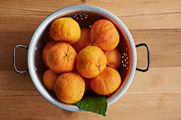 Gordijnen Home, healthy or bowl of tangerines in kitchen for wellness, organic or balanced diet for nutrition, meal or fiber. Background, above and bunch of natural ingredients with vitamin c or orange fruits © peopleimages.com