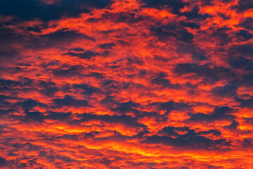 Beautiful view of sunset sky after sun has gone below the horizon. Only the sky above the horizon. Cirrus low clouds. Dramatic sunset. Fantastic dark blue thunderclouds at sunset, Natural composition.