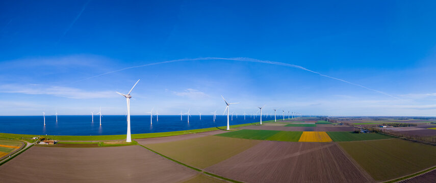 A mesmerizing aerial view capturing a wind farm near the ocean in the Netherlands Flevoland