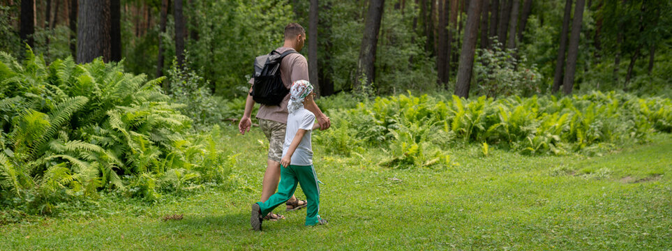 Father and son hiking in the forest 