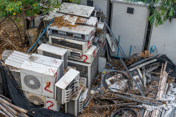 Waste air conditioning spontaneous dump with leaves in the forest - obrazy, fototapety, plakaty
