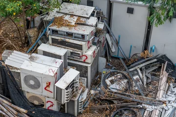 Fotobehang Waste air conditioning spontaneous dump with leaves in the forest © aapsky