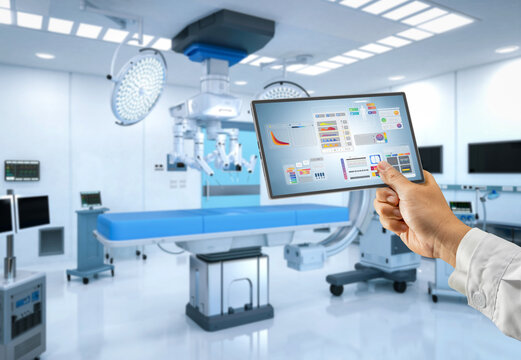 Doctor with graphic interface display in hospital room with medical machine