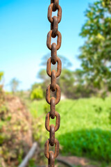 Old rusty metal chain hanging, Rusty chain links outdoors in close up, detail of a chain and hook...