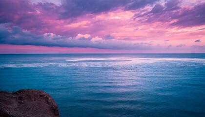 a beautiful landscape of the ocean with pink sky and clouds