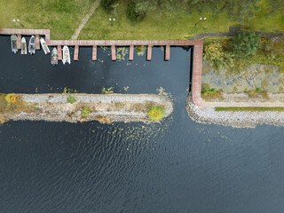 Aerial drone top view of boats standing near the pier in the river - 779409146