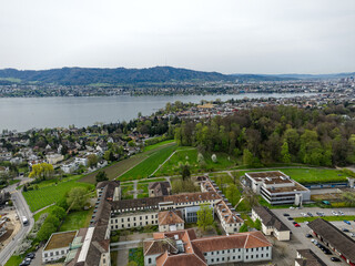 Aerial view over Swiss City of Zürich with woodland and Lake Zürich with local mountain Uetliberg...