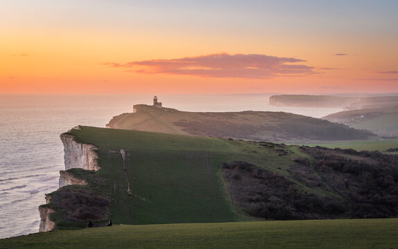 Beautiful sunset and scenery from the cliff edge of Beachy  Head with Belle Tout lighthouse on the east Sussex coast south east England UK