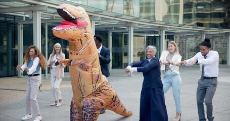 Business, people and dance outdoor in costume of inflatable dinosaur with fun and happiness at office. Funny, group and crazy team building at workplace with excited energy or comedy character