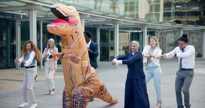 Business, people and dance outdoor in costume of inflatable dinosaur with fun and happiness at office. Funny, group and crazy team building at workplace with excited energy or comedy character