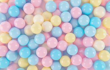 Colorful pastel blue, pink and yellow candy balls on a background