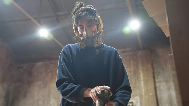 Woman carpenter sanding wood block. Feminist girl process timber bar. Male carpentry work skill. Female joiner woodwork. Feminism worker. Person use sander tool. Diy master class workshop. Job project