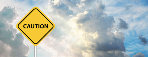 caution yellow sign on sky background
