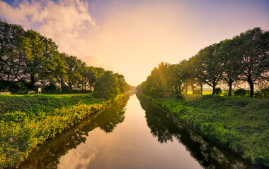 Great sunset light at the Wilhelminakanaal canal near the village of Aarle-Rixtel, The Netherlands. - obrazy, fototapety, plakaty