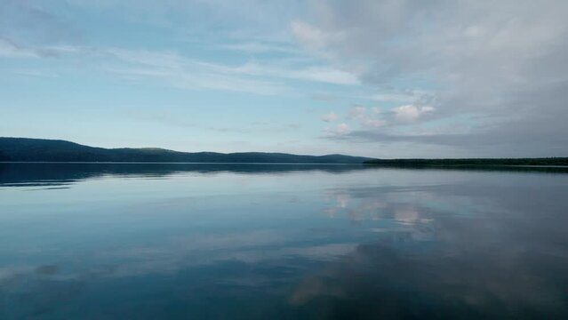 "Capture the breathtaking beauty of Lake Baikal and the Angara River from above in stunning aerial footage. Ships and boats glide through the crystal-clear waters, offering fantastic views.