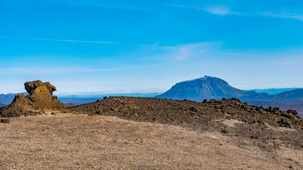Panoramic view from Askja of Herdubreid volcano in the lifeless volcanic desert in Highlands, with stones and rocks thrown by volcanic eruptions, Iceland, summer, blue sky.