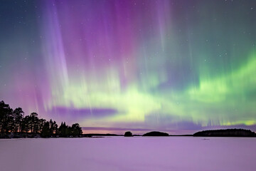 Northern lights dancing over calm lake in north of Sweden - obrazy, fototapety, plakaty