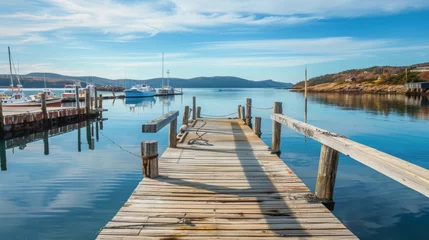 Fotobehang Wooden dock stretching out into a calm harbor with a wooden platform background © Photock Agency