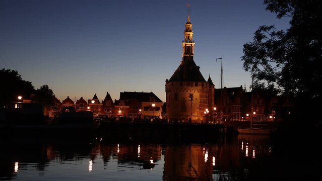 Harbour of Hoorn with sailboats at evening and the Hoofdtoren, that means the main tower. Hoorn is a harbor town at the Markermeer dating back to the 12th century, Hoorn, Netherlands