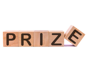 Word PRIZE is made of wooden building blocks lying on the table and on a light background. Concept.
