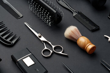 Variety of Hair Styling Tools and Accessories Displayed on a Dark Background - obrazy, fototapety, plakaty