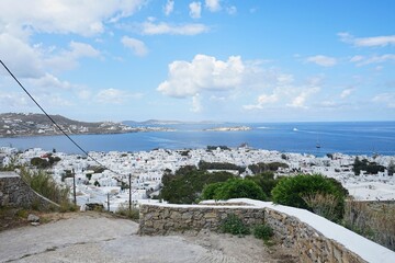 Aerial shot of the charming Old Town of Mykonos, Greece and the picturesque Aegean Sea on a sunny day