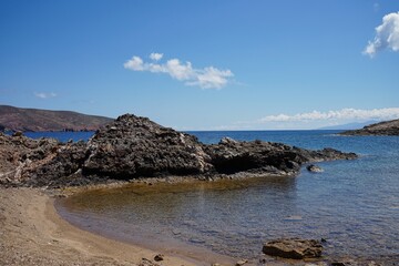 Rocky inlet along the clear waters of a secluded beach in Mykonos, Greece