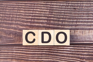 Word Business Acronym CDO Collateralized debt obligation is made of wooden building blocks. Concept.