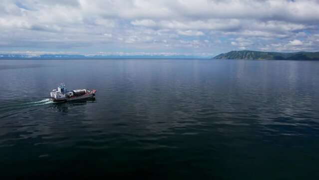 "Capture the breathtaking beauty of Lake Baikal and the Angara River from above in stunning aerial footage. Ships and boats glide through the crystal-clear waters, offering fantastic views.