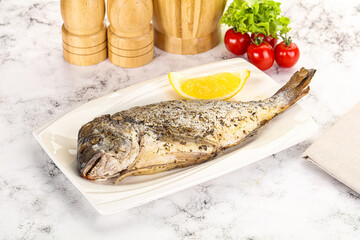 Baked Dorado fish served lemon