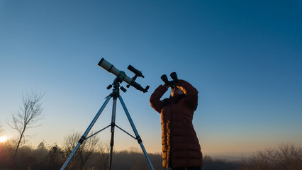Amateur astronomer observing skies with binoculars and telescope
