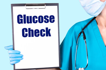 GLUCOSE CHECK text is written in a notebook held by a doctor. Medical concept.