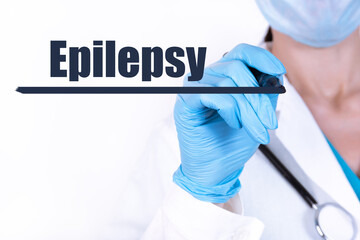 EPILEPSY text is written with a marker held by a doctor with a stethoscope. Medical concept.