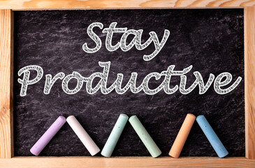 Chalkboard and color chalks with text Stay Productive