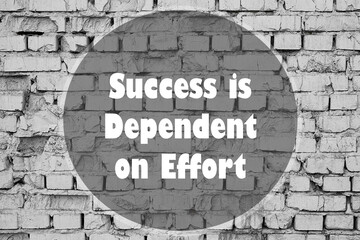 Success is Dependent on Effort written on a brick wall