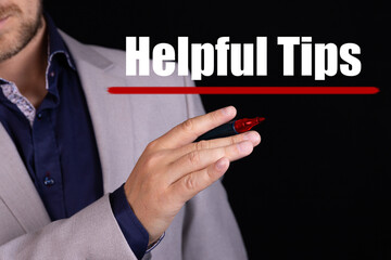HELPFUL TIPS text written by businessman hand with marker. Business concept.