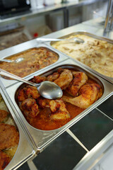 Bustling Cafeteria Serving Line During Lunchtime Offering a Variety of Dishes
