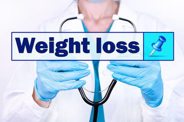 WEIGHT LOSS text is written on the background of a doctor holding a stethoscope. Medical concept.
