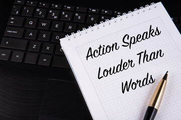 Action Speaks Louder Than Words - written on a notebook with a pen.
