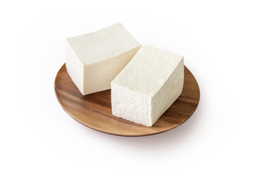 Two slices of tofu in a brown wooden plate