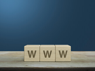 WWW letter on wood block cubes on wooden table over light blue wall, Searching system and internet...