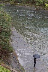 person walking along the river