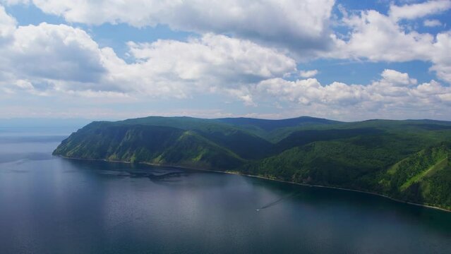 "Capture the breathtaking beauty of Lake Baikal and the Angara River from above in stunning aerial footage. Ships and boats glide through the crystal-clear waters, offering fantastic views.