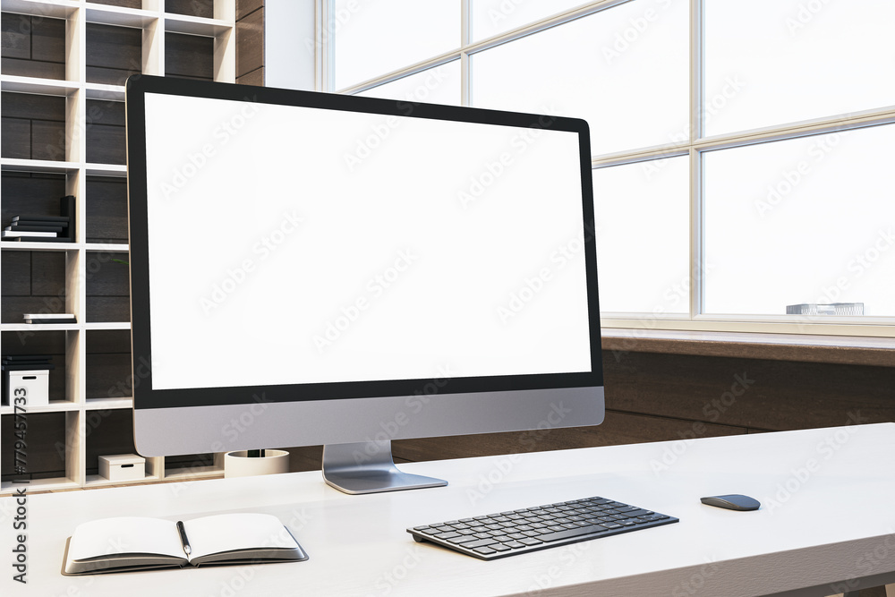 Poster Close up of designer office desktop with empty white computer monitor, window with city view and wooden shelves in the background. Mock up, 3D Rendering.