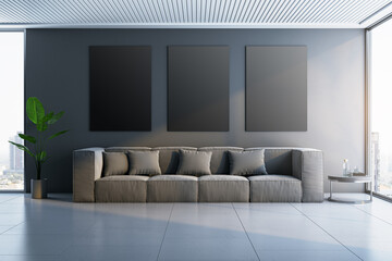 Modern concrete interior with sofa, wooden flooring,window and daylight, city view and plant. Empty black mock up frames on wall. 3D Rendering.
